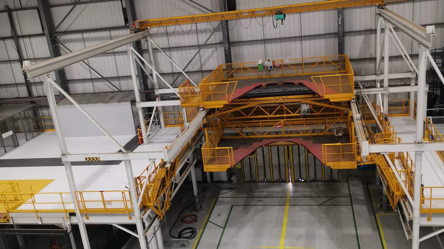 Aircraft maintenance access platforms inside a hangar with sprayed steelwork – Fixidea Coatings Ltd