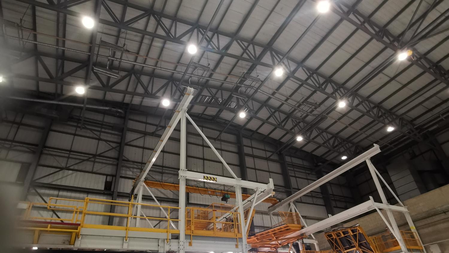 Hangar roof steel structure being sprayed at high level from access equipment – Fixidea Coatings Ltd
