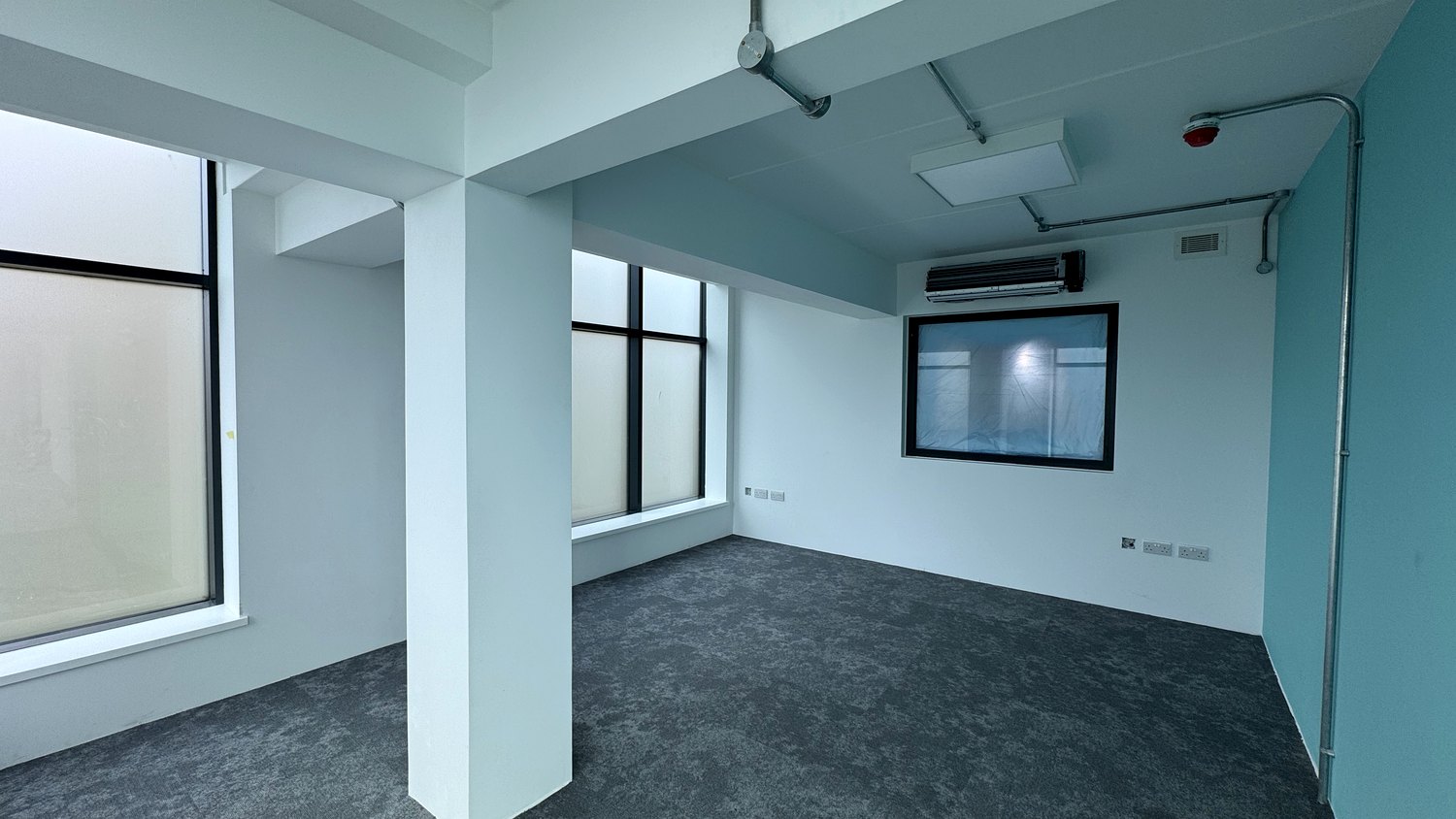 Office re-fit with walls and ceiling spray-finished and a teal feature wall – Fixidea Coatings Ltd
